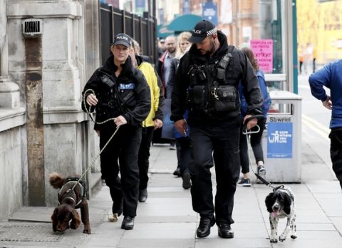 Police officers with dogs parole outside the Millennium Stadium in Cardiff, Wales, ahead of the Champions League final soccer match between Juventus and Real Madrid on Saturday June 3, 2017. (AP Photo/Kirsty Wigglesworth)