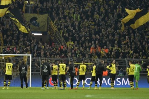 Dortmund's player stand in front of their supporters at the end of the Champions League quarterfinal second leg soccer match between Borussia Dortmund and Real Madrid in the Signal Iduna stadium in Dortmund, Germany, Tuesday, April 8, 2014. (AP Photo/Martin Meissner)