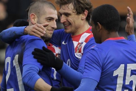 Croatia's Mladen Petric , left, celebrates his goal against South Korea with teammates during their international soccer match at Craven Cottage, London, Wednesday, Feb. 6, 2013. (AP Photo/Sang Tan)