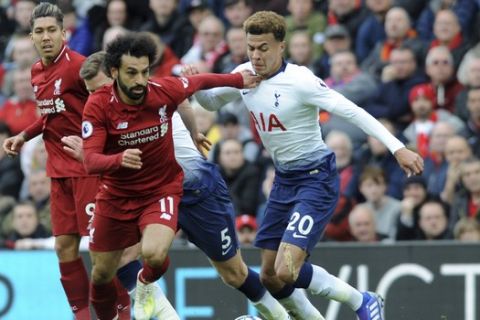 Liverpool's Mohamed Salah, front left, duels for the ball with Tottenham's Dele Alli during the English Premier League soccer match between Liverpool and Tottenham Hotspur at Anfield stadium in Liverpool, England, Sunday, March 31, 2019. (AP Photo/Rui Vieira)