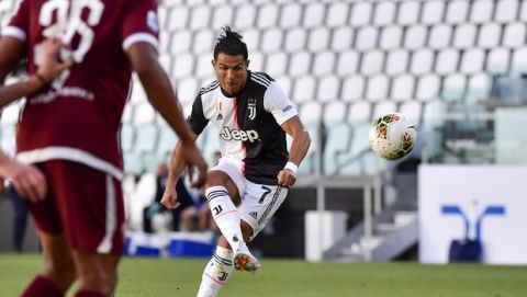 Juventus' Cristiano Ronaldo scores his side's thrid goal on a free-kick, during the Serie A soccer match between Juventus and Torino, at the Allianz Stadium in Turin, Italy, Saturday, July 4, 2020. (Marco Alpozzi/LaPresse via AP)