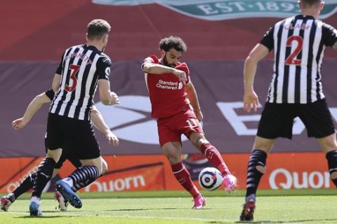 Liverpool's Mohamed Salah, center, scores his side's opening goal during the English Premier League soccer match between Liverpool and Newcastle United at Anfield stadium in Liverpool, England, Saturday, April 24, 2021. (David Klein, Pool via AP)