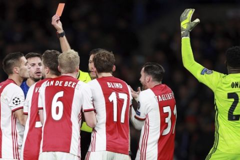 Referee Gianluca Rocchi shows a red card to Ajax's Joel Veltman during the Champions League, group H, soccer match between Chelsea and Ajax, at Stamford Bridge in London, Tuesday, Nov. 5, 2019. (AP Photo/Ian Walton)