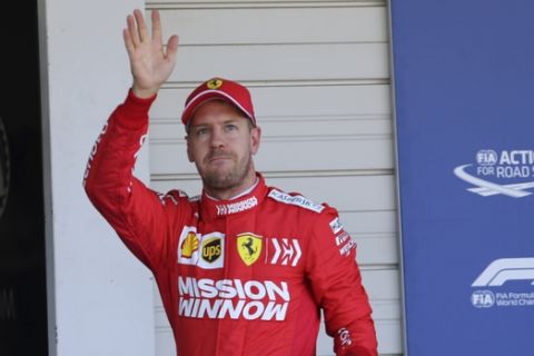 Ferrari driver Sebastian Vettel of Germany waves after the qualifying session for the Japanese Formula One Grand Prix at Suzuka Circuit in Suzuka, central Japan, Sunday, Oct. 13, 2019. Vettel grabbed pole position for the race. (AP Photo/Toru Takahashi)