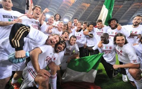 AC Milan players celebrate after their Italian Serie A football match against AS Roma in Rome's Olympic Stadium on May 7, 2011. AC Milan claimed an 18th Serie A title following a 0-0 draw at Roma on Saturday that gave them an unassailable lead at the top of the table with two games to go. AFP PHOTO / ALBERTO PIZZOLI (Photo credit should read ALBERTO PIZZOLI/AFP/Getty Images)