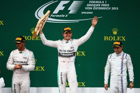 SPIELBERG, AUSTRIA - JUNE 21:  Nico Rosberg of Germany and Mercedes GP lifts the trophy on the podium next to Lewis Hamilton of Great Britain and Mercedes GP and Felipe Massa of Brazil and Williams after winning the Formula One Grand Prix of Austria at Red Bull Ring on June 21, 2015 in Spielberg, Austria.  (Photo by Clive Mason/Getty Images)