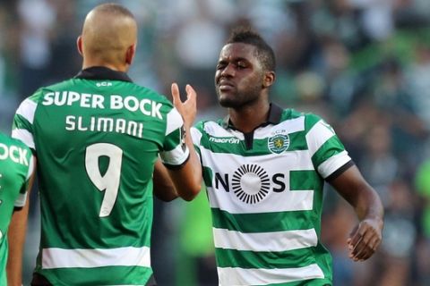 Sporting's Joel Campbell, right, celebrates with teammate Islam Slimani at the end of the Portuguese league soccer match between Sporting CP and FC Porto at the Alvalade stadium in Lisbon, Sunday, Aug. 28 2016. Sporting won 2-1. (AP Photo/Armando Franca)