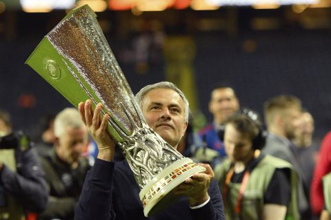 United manager Jose Mourinho holds the trophy after winning the soccer Europa League final between Ajax Amsterdam and Manchester United at the Friends Arena in Stockholm, Sweden, Wednesday, May 24, 2017. United won 2-0. (AP Photo/Martin Meissner)