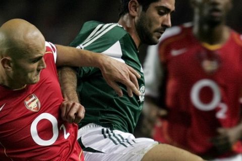 Arsenal's Pascal Cygan, left, in a tackle with Michael Konstantinou of Panathinaikos in the UEFA Champions League Group E, fixture at Highbury Stadium, London, Tuesday Nov.2, 2004, between Arsenal FC and Panathinaikos FC from Greece.The game ended in a 1-1 draw. (AP Photo/Alastair Grant)  