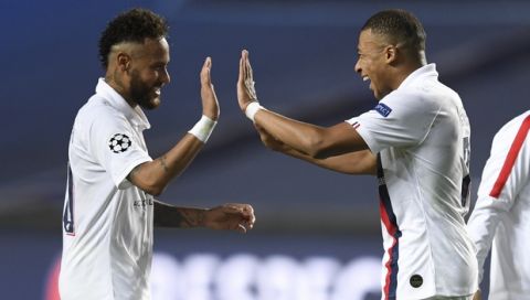 PSG's Neymar, left, celebrates with teammate PSG's Kylian Mbappe, right, after his team's win in the Champions League quarterfinal match between Atalanta and PSG at Luz stadium, Lisbon, Portugal, Wednesday, Aug. 12, 2020. (David Ramos/Pool Photo via AP)