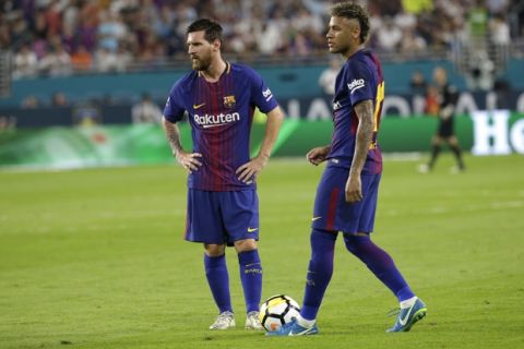 Barcelona's Lionel Messi, left, and Neymar, right, stand on the field during a break in the action during the first half of an International Champions Cup soccer match against Real Madrid, Saturday, July 29, 2017, in Miami Gardens, Fla. (AP Photo/Lynne Sladky)