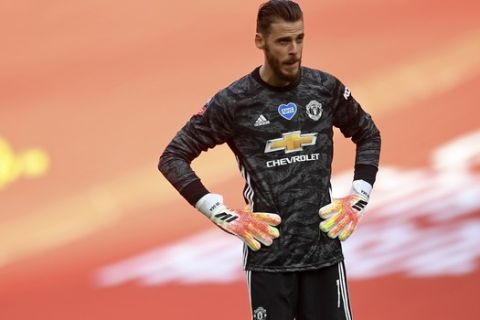 Manchester United's goalkeeper David de Gea stands hands on hips after conceding the second goal during the English FA Cup semifinal soccer match between Chelsea and Manchester United at Wembley Stadium in London, England, Sunday, July 19, 2020. (Andy Rain, Pool via AP)