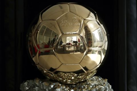 The Golden Ball is pictured in Boulogne-Billancourt, outside Paris, Friday, Sept. 21, 2018. A woman will lift the most prestigious individual trophy in soccer for the first time this year. Awarded every year by France Football magazine since Stanley Matthews won it in 1956, the Ballon d'Or for the best player of the year will be given to both a woman and a man on Dec. 3 in Paris.(AP Photo/Christophe Ena)