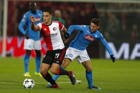 Feyenoord's Sofyan Amrabat, left, challenges for the ball with Napoli's Dries Mertens during a Champions League Group F soccer match between Feyenoord and Napoli at the Kuip stadium in Rotterdam, Netherlands, Wednesday, Dec. 6, 2017. (AP Photo/Peter Dejong)