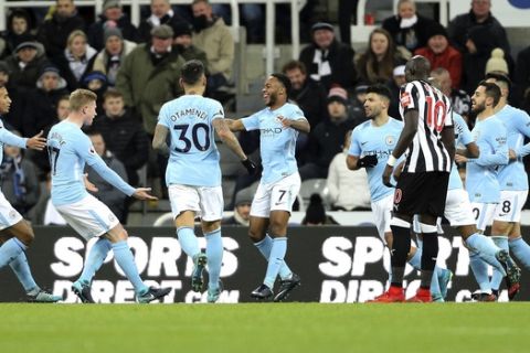 Manchester City's Raheem Sterling, center, celebrates with teammates after scoring his side's first goal of the game during their English Premier League soccer match against Newcastle United at St James' Park, Newcastle, England, Wednesday, Dec. 27, 2017. (Owen Humphreys/PA via AP)