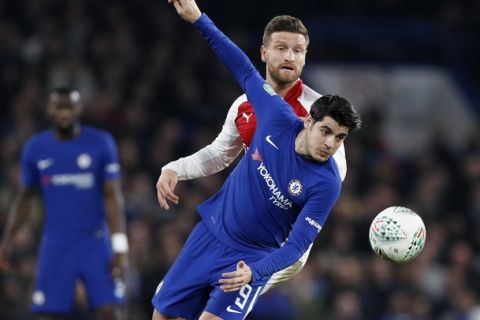 Chelsea's Alvaro Morata, right, vies for the ball with Arsenal's Shkodran Mustafi during the English League Cup semifinal, first leg, soccer match between Chelsea and Arsenal at Stamford Bridge stadium in London, Wednesday, Jan. 10, 2018. (AP Photo/Kirsty Wigglesworth)