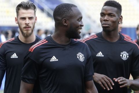 Manchester United's David de Gea, left, Romelu Lukaku, center and Paul Pogba, right, attend a training session at Philip II Arena in Skopje, Macedonia, Monday, Aug. 7, 2017, a day ahead of UEFA Super Cup final soccer match with Real Madrid. (AP Photo/Boris Grdanoski)