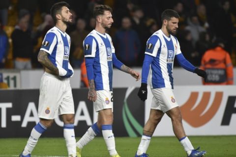 Espanyol players walk on the pitch in dejection at the end of the Europa League round of 32 match between Wolverhampton Wanderers and Espanyol at the Molineux Stadium, in Wolverhampton, England, Thursday, Feb. 20, 2020. (AP Photo/ Rui Vieira)