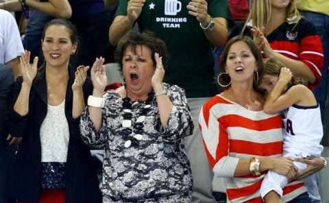 Debbie (C) and Whitney (R), the mother and sister respectively of swimmer Michael Phelps of the U.S., cheer Phelps on as he swims in the men's 200m individual medley final during the London 2012 Olympic Games at the Aquatics Centre August 2, 2012. REUTERS/Michael Dalder