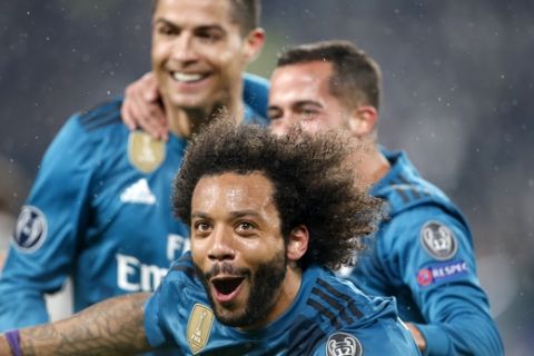 Real Madrid's Marcelo, front,celebrates after scoring his side's third goal during the Champions League first leg quarter final soccer match between Juventus and Real Madrid, at Juventus Stadium in Turin, Italy, Tuesday, April 3, 2018. (AP Photo/Antonio Calanni)