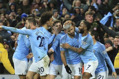 Manchester City's Sergio Aguero, No 10, celebrates with teammates after scoring the opening goal of the game during their English Premier League soccer match between Manchester City and Liverpool at the Ethiad stadium, Manchester England, Thursday, Jan. 3, 2019. (AP Photo/Jon Super)