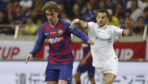 Barcelona's Antoine Griezmann, left, and Chelsea's Pedro, right, compete for the ball during a friendly soccer match between FC Barcelona and Chelsea FC in Saitama, north of Tokyo, Tuesday, July 23, 2019. Chelsea won 2-1. (AP Photo/Eugene Hoshiko)