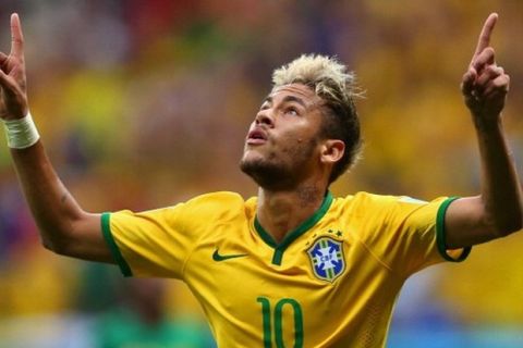 BRASILIA, BRAZIL - JUNE 23:  Neymar of Brazil celebrates scoring his team's second goal and his second of the game during the 2014 FIFA World Cup Brazil Group A match between Cameroon and Brazil at Estadio Nacional on June 23, 2014 in Brasilia, Brazil.  (Photo by Clive Brunskill/Getty Images)
