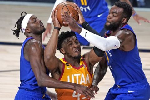 Utah Jazz's Donovan Mitchell, center, goes up for a shot as Denver Nuggets' Jerami Grant, left, and Paul Millsap, right, defend during the second half of an NBA basketball first round playoff game Sunday, Aug. 30, 2020, in Lake Buena Vista, Fla. (AP Photo/Ashley Landis)