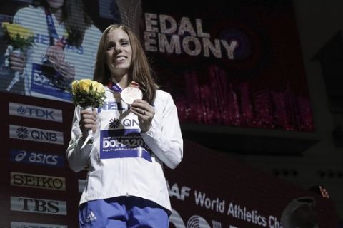 Katerina Stefanidi of Greece, bronze medalist in the women's pole vault, takes part in the medal ceremony at the World Athletics Championships in Doha, Qatar, Monday, Sept. 30, 2019. (AP Photo/Nariman El-Mofty)