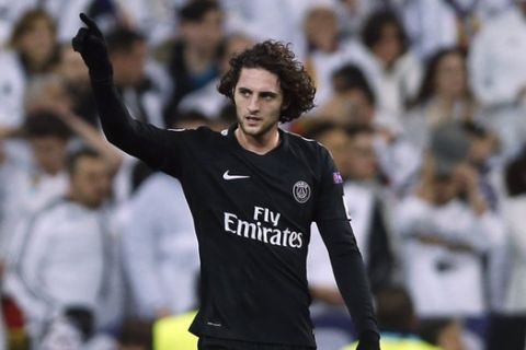 PSG's Adrien Rabiot celebrates after scoring the opening goal during a Champions League Round of 16 first leg soccer match between Real Madrid and Paris Saint Germain at the Santiago Bernabeu stadium in Madrid, Spain, Wednesday, Feb. 14, 2018. (AP Photo/Francisco Seco)