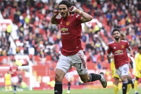 Manchester United's Edinson Cavani celebrates scoring their first goal during the English Premier League soccer match between Manchester United and Fulham at Old Trafford stadium in Manchester, England, Tuesday, May 18, 2021. (AP Photo/Laurence Griffiths, Pool)