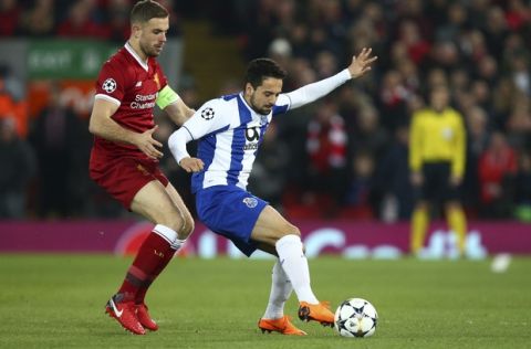 Liverpool's Jordan Henderson, left, vies for the ball with Porto's Bruno Costa during the Champions League round of 16, second leg, soccer match between Liverpool and FC Porto at Anfield Stadium, Liverpool, England, Tuesday March 6, 2018. (AP Photo/Dave Thompson)