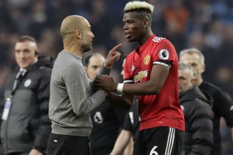 Manchester City coach Pep Guardiola talks with Manchester United's Paul Pogba at the end of the English Premier League soccer match between Manchester City and Manchester United at the Etihad Stadium in Manchester, England, Saturday April 7, 2018. (AP Photo/Matt Dunham)