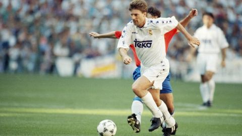 Read Madrids Danish forward Michael Laudrup is tackled by a Zaragoza player during a first division league soccer match in Madrid on Sunday, April 9, 1995. Real won the match 3-0. (AP Photo/Denis Doyle)