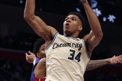 Milwaukee Bucks forward Giannis Antetokounmpo (34) makes a layup as Detroit Pistons forward Christian Wood defends during the first half of an NBA basketball game, Wednesday, Dec. 4, 2019, in Detroit. (AP Photo/Carlos Osorio)