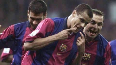 F.C. Barcelona's Brazilian forward Rivaldo, center, celebrates with teamates Pepi Guardiola, left, and Sergi after scoring a goal against Real Madrid in a Spanish league soccer match in Real's Santiago Bernabeu stadium in Madrid, Spain, Saturday, March 3 2001. The match ended 2-2. (AP Photo/Zaheeruddin Abdullah)