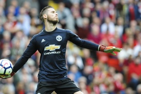 Manchester United goalkeeper David de Gea throws the ball during the English Premier League soccer match between Liverpool and Manchester United at Anfield, Liverpool, England, Saturday, Oct. 14, 2017. (AP Photo/Rui Vieira)