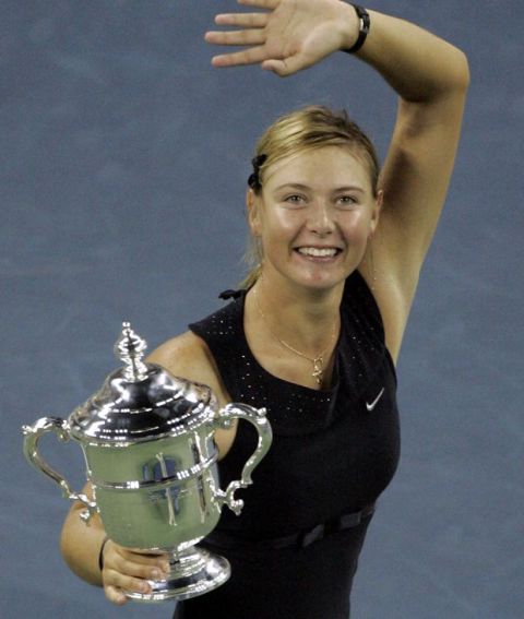 Maria Sharapova gestures as she holds her women's singles championship trophy after defeating Justine Henin-Hardenne at the US Open tennis tournament in New York, Saturday, Sept. 9, 2006. (AP Photo/Julie Jacobson)