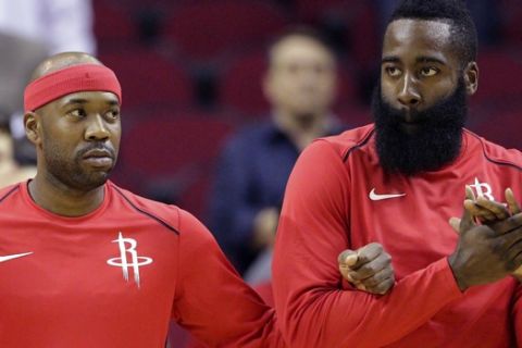Houston Rockets players Chris Paul, Bobby Brown and James Harden link arms during the National Anthem before an NBA exhibition basketball game against the Shanghai Sharks Thursday, Oct. 5, 2017, in Houston. (AP Photo/Michael Wyke)