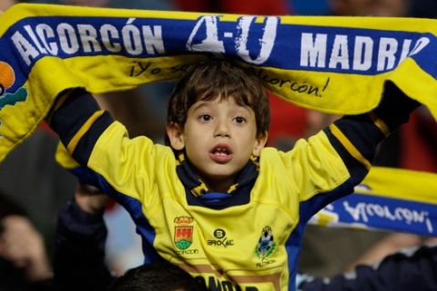 A young supporter of Spanish third division soccer team Alcorcon displays scarf, at the end of their Copa del Rey second leg soccer match with Real Madrid Tuesday, Nov. 10 2009, at Real Madrid's Santiago Bernabeu stadium. Real Madrid won the match 1-0 but were eliminated from the tournament after having lost the first leg 4-0. (AP Photo/Armando Franca)