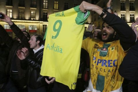 Supporters gather to pay tribute to Argentinian soccer player Emiliano Sala, in Nantes, western France, Tuesday, Jan. 22, 2019. The search for the missing plane taking Argentine soccer player Emiliano Sala to his new team in Wales was called off for the night on Tuesday with authorities not expecting to find any survivors in the English Channel. (AP Photo/David Vincent)