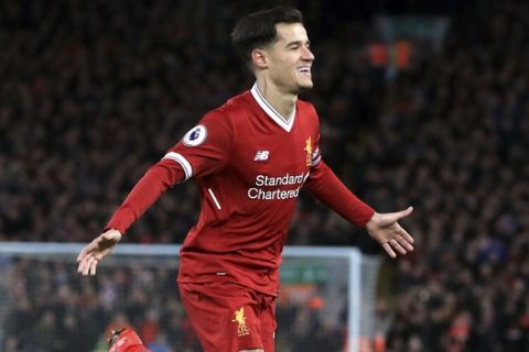 Liverpool's Philippe Coutinho celebrates scoring his side's first goal of the game against Swansea City during the English Premier League soccer match at Anfield, Liverpool, England, Tuesday Dec. 26, 2017. (Peter Byrne/PA via AP)