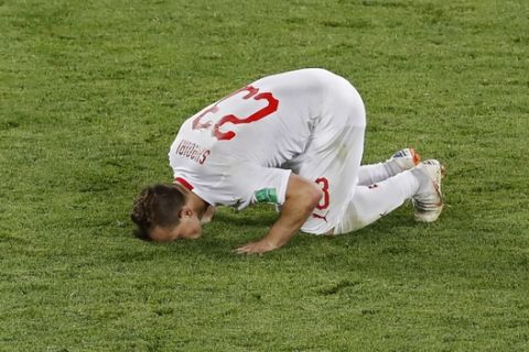 Switzerland's Xherdan Shaqiri kisses the pitch after scoring his side's second goal during the group E match between Switzerland and Serbia at the 2018 soccer World Cup in the Kaliningrad Stadium in Kaliningrad, Russia, Friday, June 22, 2018. Shaqiri scored once in Switzerland's 2-1 victory. (AP Photo/Antonio Calanni)