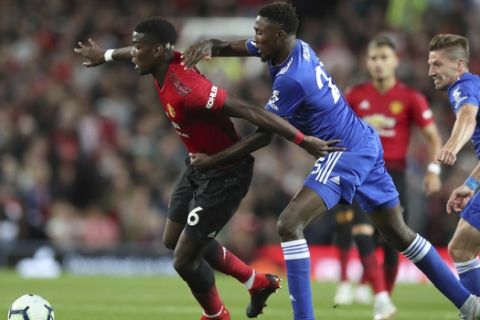Manchester United's Paul Pogba, left vies for the ball with Leicester City's Wilfred Ndidi during the English Premier League soccer match between Manchester United and Leicester City at Old Trafford, in Manchester, England, Friday, Aug. 10, 2018. (AP Photo/Jon Super)