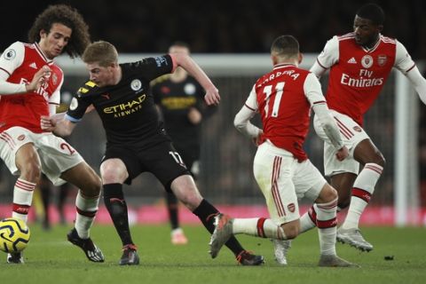 Manchester City's Kevin De Bruyne, second left, Arsenal's Matteo Guendouzi, left, Arsenal's Lucas Torreira, second right, and Arsenal's Ainsley Maitland-Niles during the English Premier League soccer match between Arsenal and Manchester City, at the Emirates Stadium in London, Sunday, Dec. 15, 2019. (AP Photo/Ian Walton)