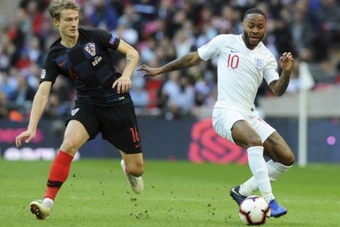 Croatia's Tin Jedvaj, left, vies for the ball with England's Raheem Sterling during the UEFA Nations League soccer match between England and Croatia at Wembley stadium in London, Sunday Nov. 18, 2018. (AP Photo/Rui Vieira)