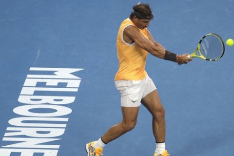 Spain's Rafael Nadal makes a forehand return to Greece's Stefanos Tsitsipas during their semifinal at the Australian Open tennis championships in Melbourne, Australia, Thursday, Jan. 24, 2019. (AP Photo/Mark Schiefelbein)