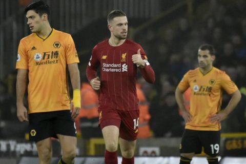 Liverpool's Jordan Henderson, center, celebrates after scoring his side's opening goal during the English Premier League soccer match between Wolverhampton Wanderers and Liverpool at the Molineux Stadium in Wolverhampton, England, Thursday, Jan. 23, 2020. (AP Photo/Rui Vieira)