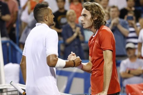 Nick Kyrgios, left, of Australia, and Stefanos Tsitsipas, of Greece, meet at the net after Kyrgios defeated Tsitsipas in a semifinal at the Citi Open tennis tournament Saturday, Aug. 3, 2019, in Washington. (AP Photo/Patrick Semansky)