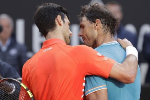 Rafael Nadal, right, of Spain embraces Novak Djokovic of Serbia at the end of their final match at the Italian Open tennis tournament, in Rome, Sunday, May 19, 2019. (AP Photo/Gregorio Borgia)